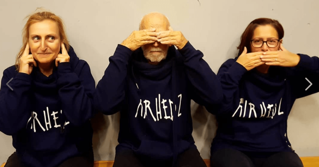 Tina, Guy, and Jade all wear Airhedz hoodies, mimicking the 'hear no evil, see no evil, speak no evil' monkeys.